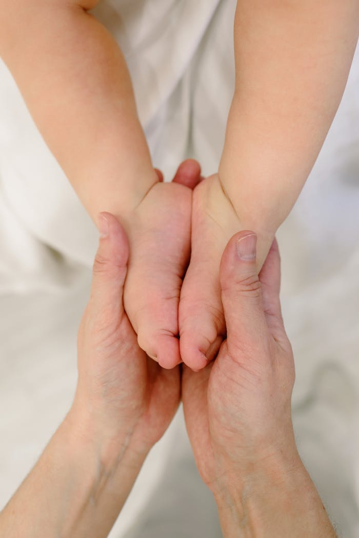Mastering the First Impression: Your intriguing post title goes here Close-up of hands massaging baby feet, symbolizing tenderness and care.